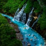 A glimpse of Giessbach Waterfalls descending into Lake Brienz amidst the Alps.