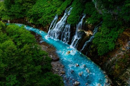 A glimpse of Giessbach Waterfalls descending into Lake Brienz amidst the Alps.