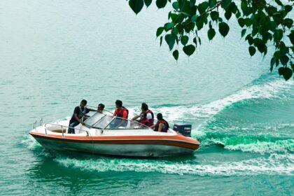 An image of people enjoying a boat ride in the Kankaria lake during the day in Gujarat.