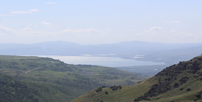 The Sea of Galilee sits among verdant hills in Israel as seen from afar.