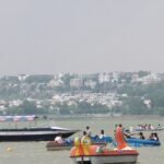 An image of Upper Lake in Madhya Pradesh with people enjoying boating and the surrounding