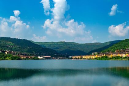 A scenic view of one of the most beautiful lakes in Pune, with golden sunset reflections on the water