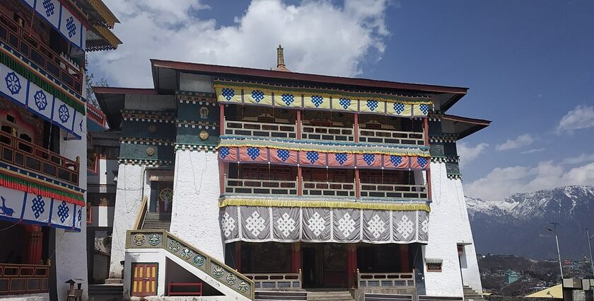 A stunning image of Tawang Monastery in Arunachal Pradesh, surrounded by snow-capped mountains.