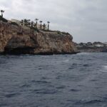 A serene view of the coastline of Mallorca during day time - scuba diving in Mallorca