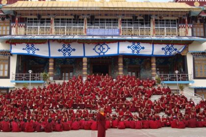 An image of the Sera Jey Monastery nestled against the backdrop of Tibetan mountains.