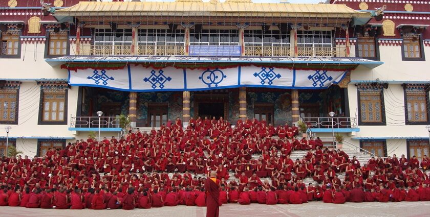 An image of the Sera Jey Monastery nestled against the backdrop of Tibetan mountains.