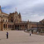 Tourists exploring the famous Plaza de Espana, a top thing to do in Seville.