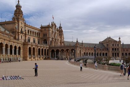 Tourists exploring the famous Plaza de Espana, a top thing to do in Seville.