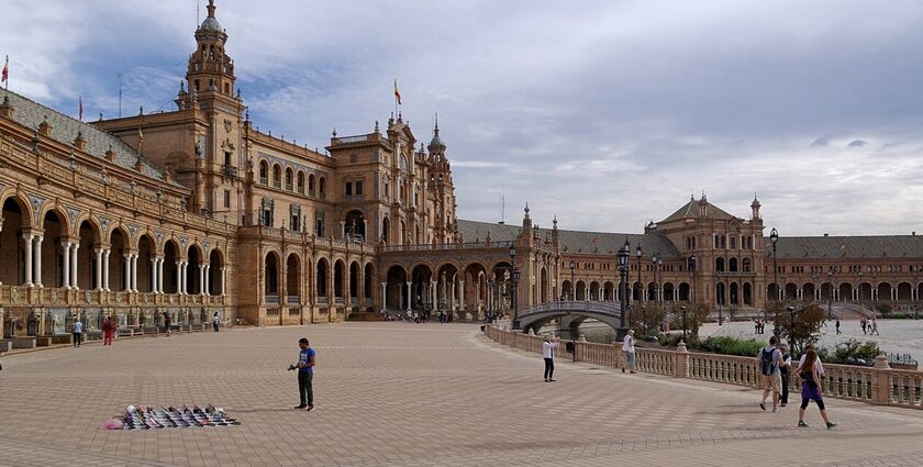 Tourists exploring the famous Plaza de Espana, a top thing to do in Seville.