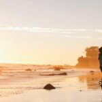 A couple dancing on the beach, sharing a romantic moment this Valentine’s Day in Sydney.