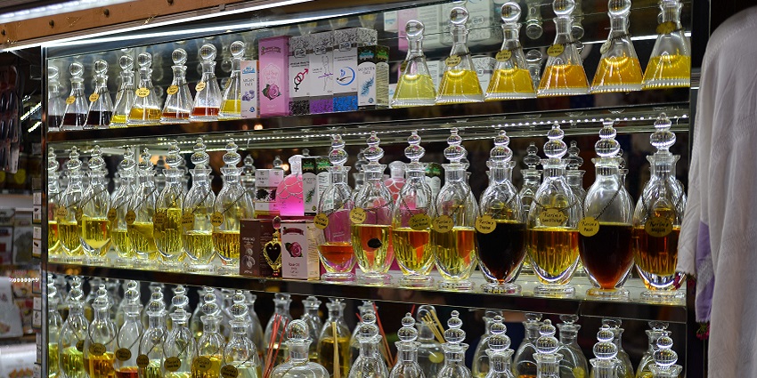 A vibrant display of traditional Arabian perfumes, beautifully arranged in glass bottles.