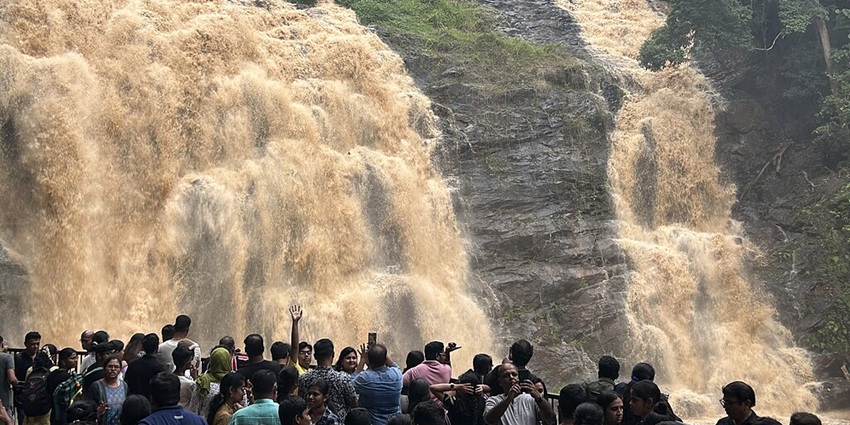 A sea of tourists enjoy views of a magnificent Abbey Falls at its best