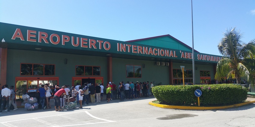 Terminal building of Abel Santamaria Airport with green architectural building and people