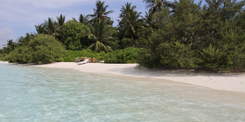 An astonishing view of Maldives featuring crystal-clear waters and golden sands.
