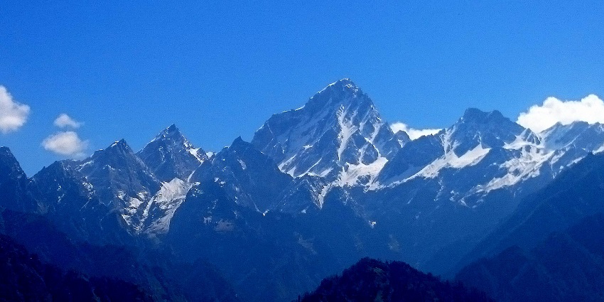 An image of Brahm-om Parvat, a mountain with distinct rock formations in a remote region.