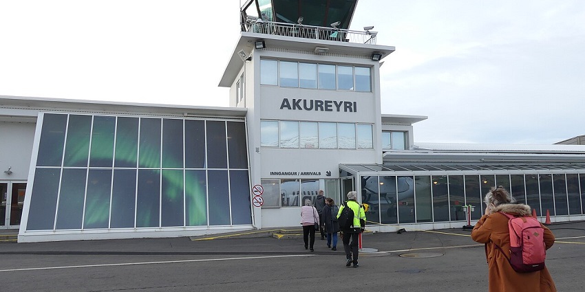 A view of Akureyri Airport in Iceland, showing the terminal building and clear sky.