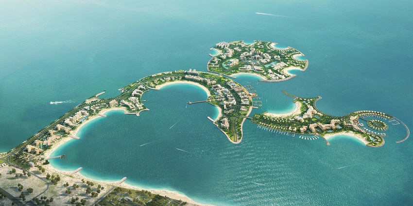 An aerial view of a series of uniquely shaped islands with buildings and greenery.