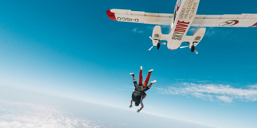 A sky diver soaring in the sky above in Algarve, one of the best places for skydiving in Europe