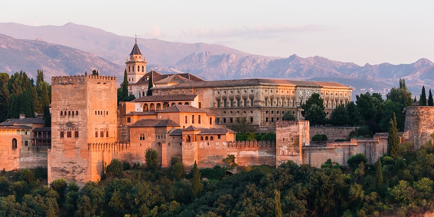 The Charles V Palace at Alhambra glows at dawn, highlighting its grand Renaissance design
