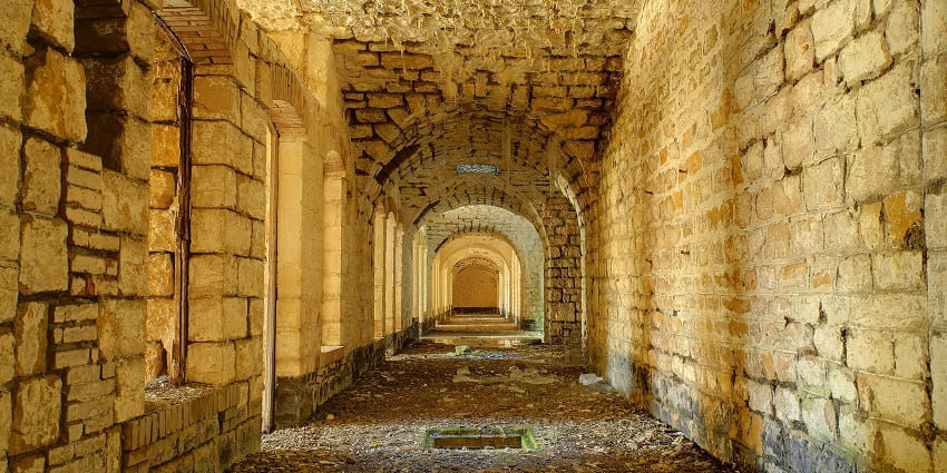 A scenic view of Ambagarh Fort surrounded by lush green hills and a soothing atmosphere.