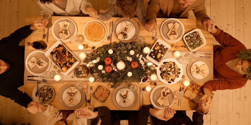 Aerial view of people enjoying a festive dinner with the best food in New Zealand.