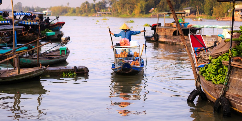 A glimpse of Amphawa featuring shimmering blue waters and colourful boats.