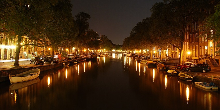 A nighttime view of Amsterdam, one of the best places to visit for New Year’s Eve.