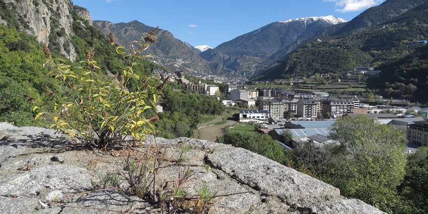 Aerial view of the majestic Andorran Cliffs surrounding the cluster of buildings near El Pasa de la Casa.