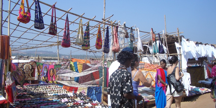 A bustling flea market in Goa, filled with handicrafts and beachwear.