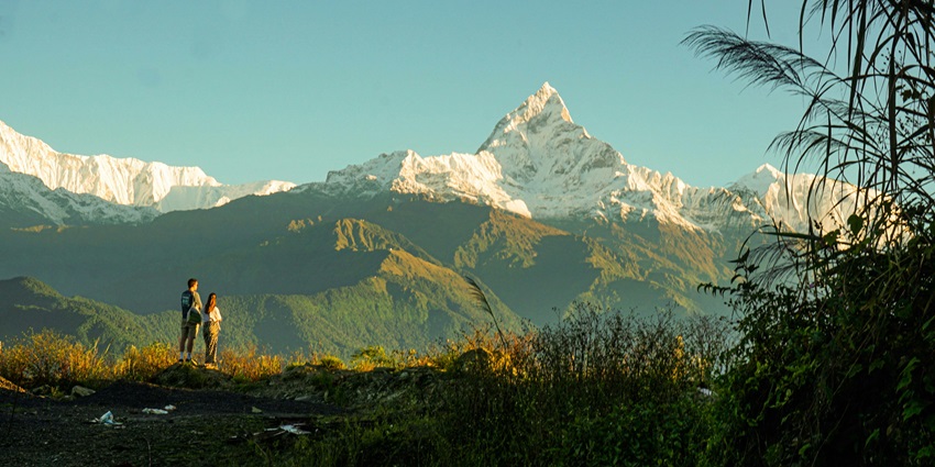 A hiker walking on the Annapurna Circuit trail, enjoying one of the places for trekking.