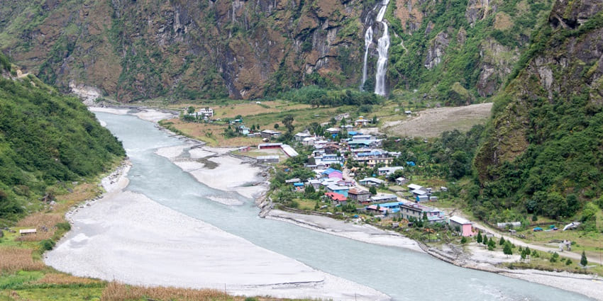 An image of Annapurna Circuit next to the roadside waterfall, one of the waterfalls in Nepal.