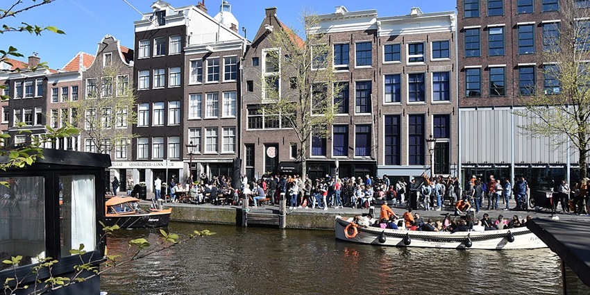 The Anne Frank House in Amsterdam, a historic museum with visitors near the entrance.