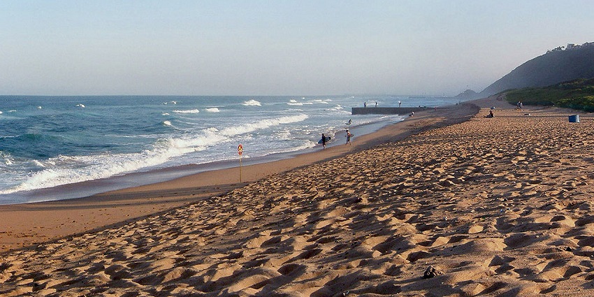 Surfers and beachgoers, exploring the waves at Ansteys Beach, one of the beaches in Durban.
