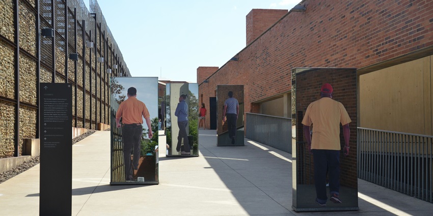 People walking at a street display at the Apartheid Museum in Johannesburg, South Africa.