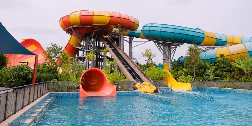 Kids enjoying a water splash slide ride at Aqua Marine Water Park in West Bengal.