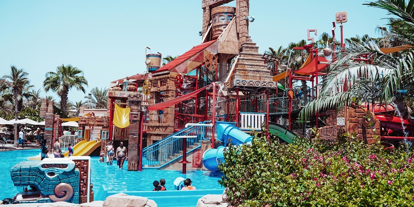 A man jumping from a surfboard in a swimming pool at Aquatic Bengal Water Park.