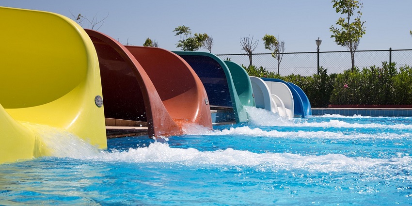 An image showing a water park with a water slide, similar to the Arcadia Backpackers