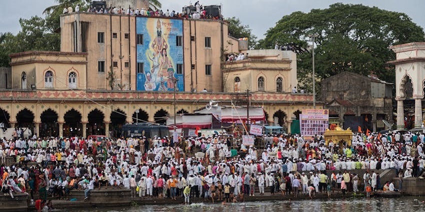Devotees near the ghat for Dnyaneshwar Jayanti showing respect in Alandi Maharashtra