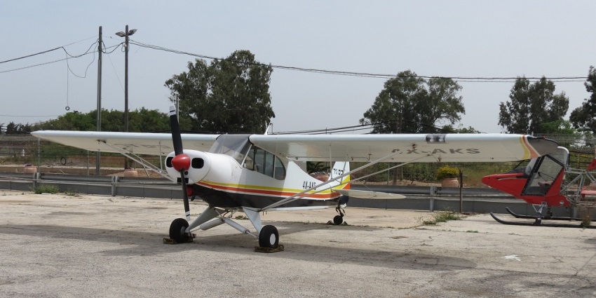 A single engine aircraft is taxied near a runway at one of the airports in Solomon Islands