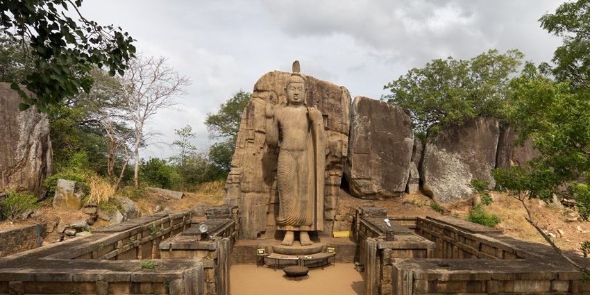A view of the iconic Avukana Buddha Statue exuding rustic charm and vintage beauty.
