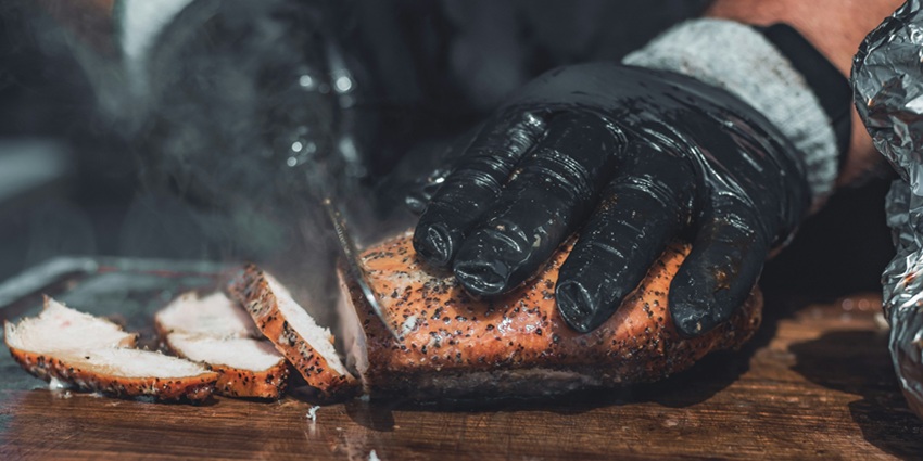 An image showing a BBQ getting grilled, one of the most famous foods in the USA.