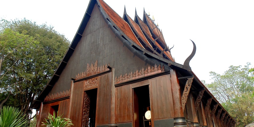 The mysterious Baan Dam Museum (Black House) in Chiang Rai, with dark wooden buildings.