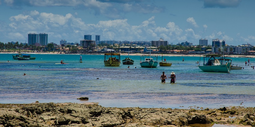 A picture of a beautiful beach in Puerto Rico with numerous boats visible in the sea