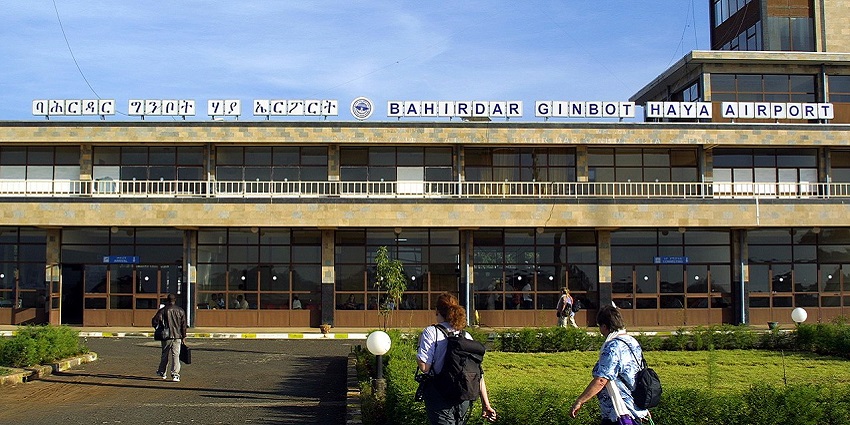 Bahir Dar Airport terminal under a clear blue sky, with passengers outside the main building