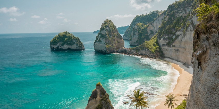Places to visit in July in Asia include a tropical paradise with lush rice terraces, volcanic mountains, and serene beaches