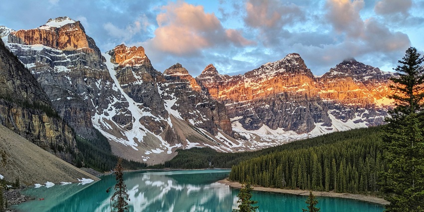 A breathtaking view of Moraine Lake with turquoise waters surrounded by majestic mountains