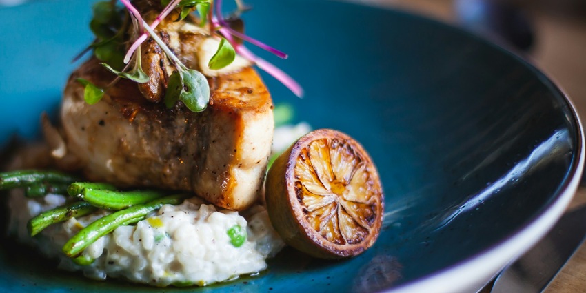 An image showing bangers and mash served on a plate in a diner, ready to be enjoyed.