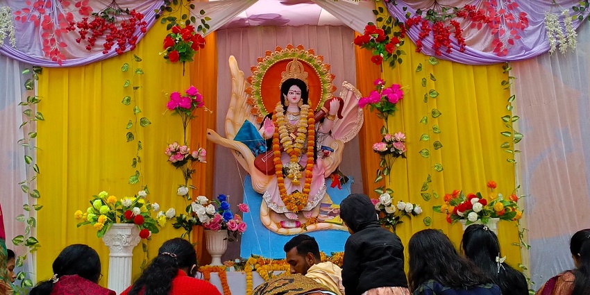 An image of a goddess decorated with ornaments and flowers to celebrate Basant Panchami.