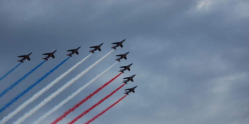 Military aircraft perform a flyover during Bastille Day celebrations in Paris, France