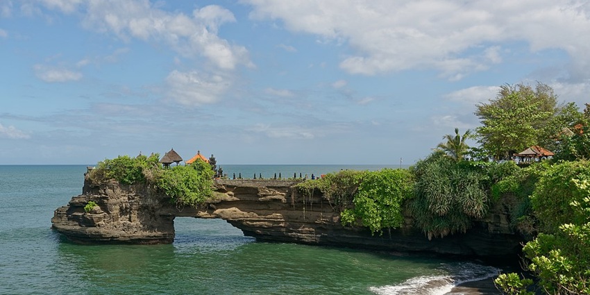 A stunning seaside temple perched on a rocky cliff with ocean views